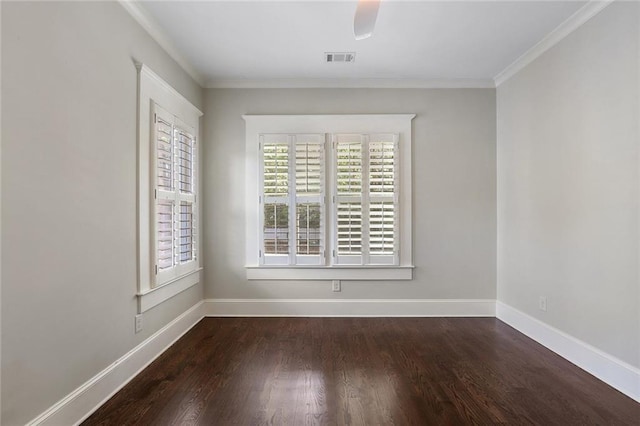 spare room with dark wood-type flooring and a healthy amount of sunlight