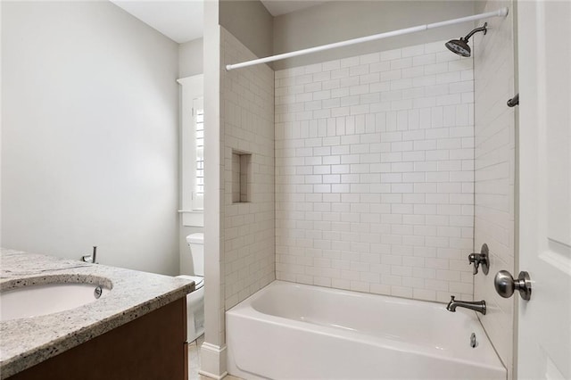 full bathroom with tiled shower / bath combo, vanity, and toilet