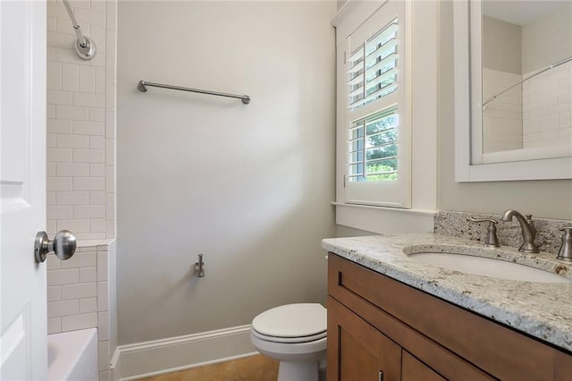 full bathroom with tile flooring, tiled shower / bath, toilet, and vanity