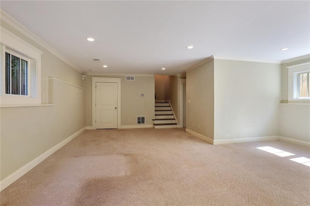 basement featuring light carpet and ornamental molding