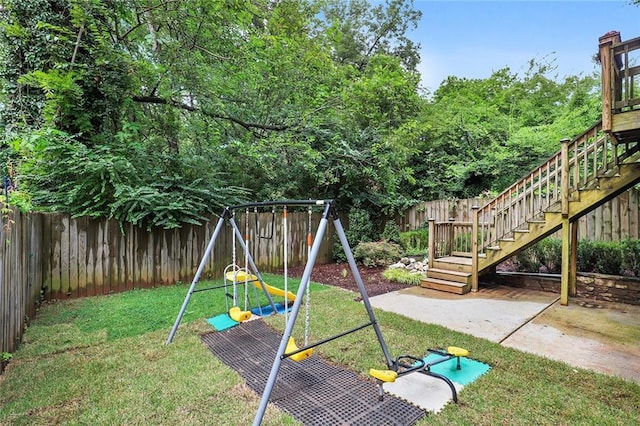 view of jungle gym featuring a lawn and a patio