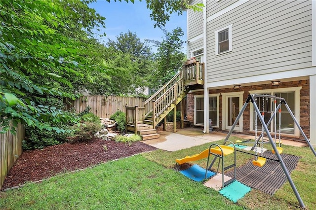 view of yard featuring a wooden deck and a patio area