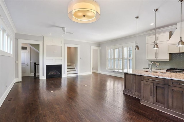 kitchen featuring decorative light fixtures, dark hardwood / wood-style floors, ceiling fan, white cabinets, and tasteful backsplash