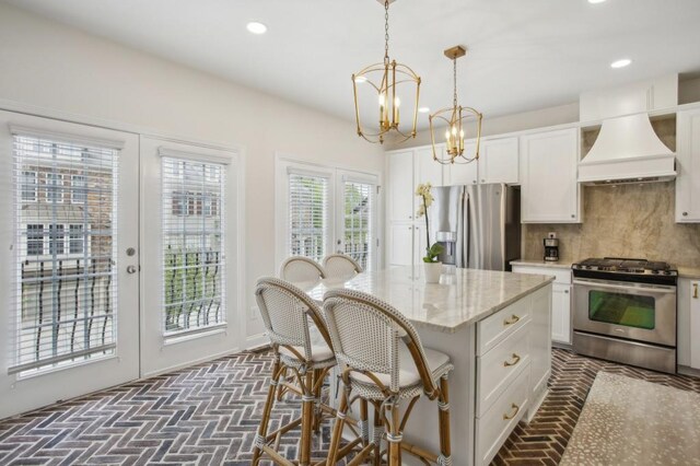 346 Ardmore Ct, Atlanta, GA 30309 - kitchen with premium range hood, french doors, stainless steel appliances, and brick floor