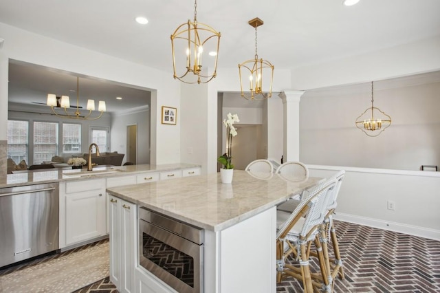 346 Ardmore Ct, Atlanta, GA 30309 - kitchen featuring brick floor, appliances with stainless steel finishes, a sink, and an inviting chandelier