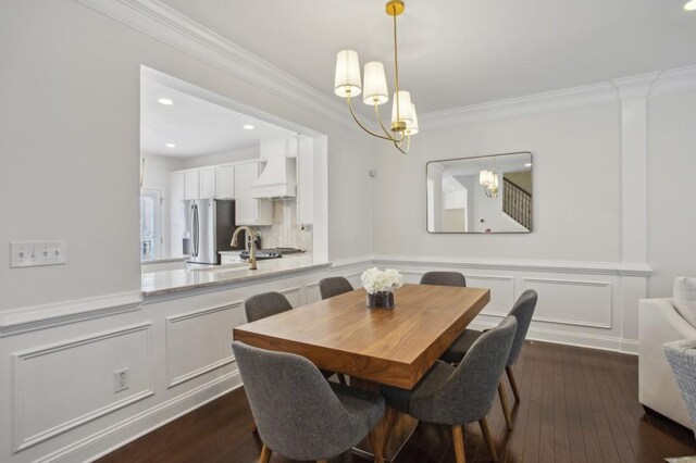 346 Ardmore Ct, Atlanta, GA 30309 - dining room featuring ornamental molding, dark wood-style floors, a notable chandelier, and a wainscoted wall