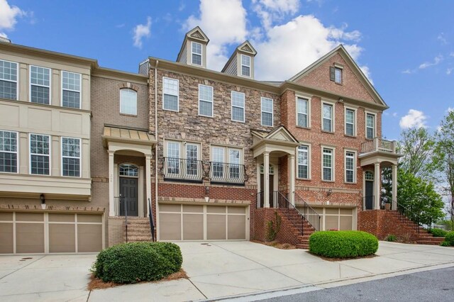 346 Ardmore Ct, Atlanta, GA 30309 - multi unit property with an attached garage, a balcony, brick siding, and concrete driveway