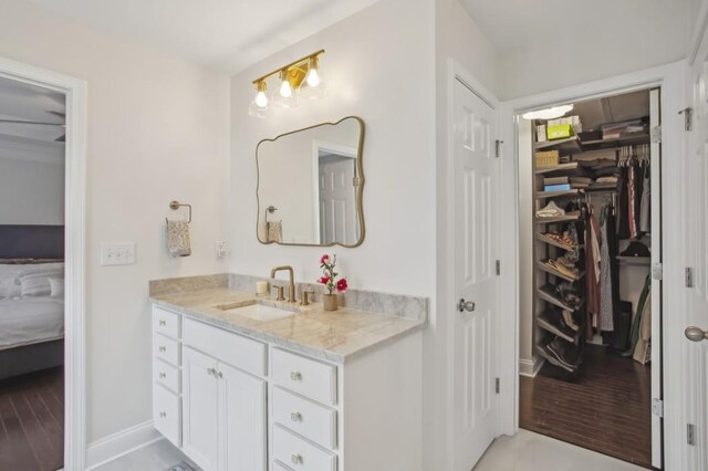 346 Ardmore Ct, Atlanta, GA 30309 - bathroom with a walk in closet, baseboards, vanity, and connected bathroom