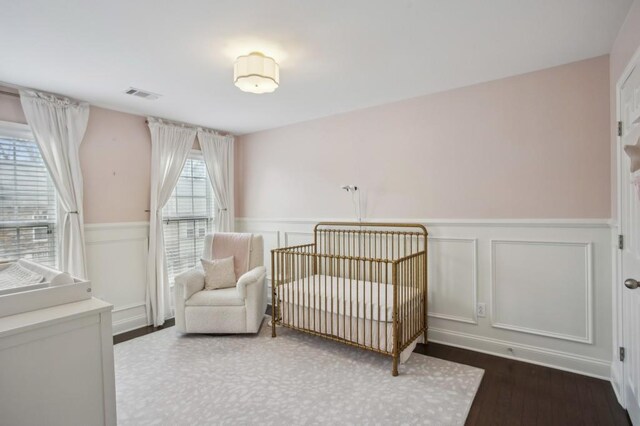 346 Ardmore Ct, Atlanta, GA 30309 - bedroom featuring a decorative wall, visible vents, and wainscoting