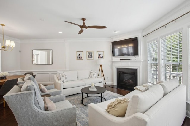 346 Ardmore Ct, Atlanta, GA 30309 - living area featuring ceiling fan with notable chandelier, a glass covered fireplace, dark wood finished floors, ornamental molding, and recessed lighting