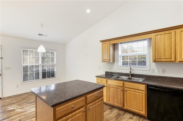 kitchen featuring light wood-type flooring, black dishwasher, plenty of natural light, and sink