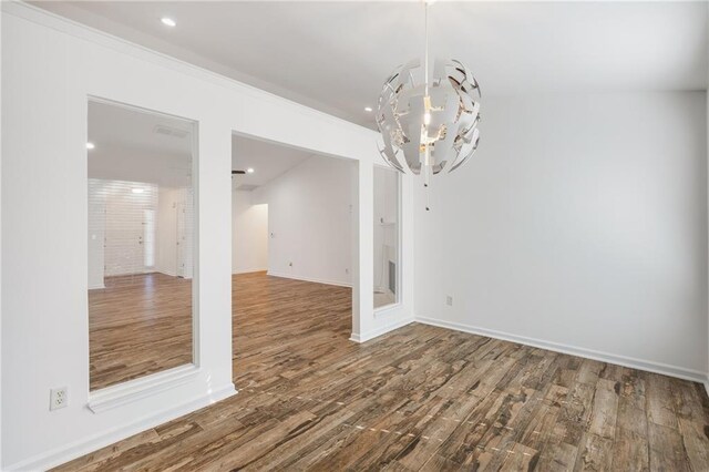 unfurnished dining area with hardwood / wood-style flooring and a notable chandelier