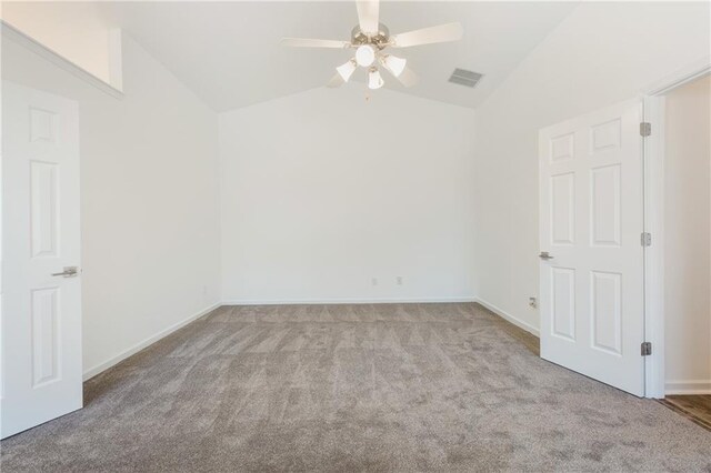 empty room featuring ceiling fan, light colored carpet, and lofted ceiling