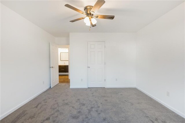 unfurnished bedroom featuring ceiling fan and light carpet