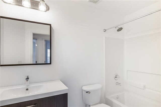 full bathroom featuring bathtub / shower combination, vanity, and toilet