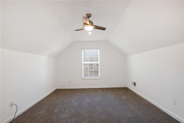 bonus room with ceiling fan, dark carpet, and lofted ceiling