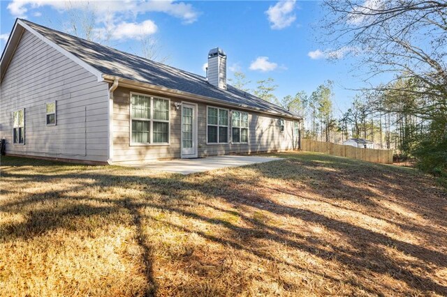 rear view of house with a patio area and a yard