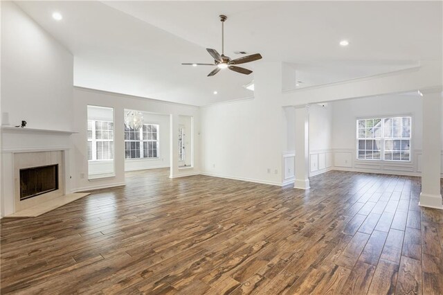 unfurnished living room featuring a tile fireplace, ceiling fan, dark hardwood / wood-style flooring, and high vaulted ceiling