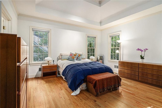 80 Stratford Pl NE, Atlanta, GA 30342 - bedroom with a tray ceiling, light wood-style flooring, multiple windows, and crown molding