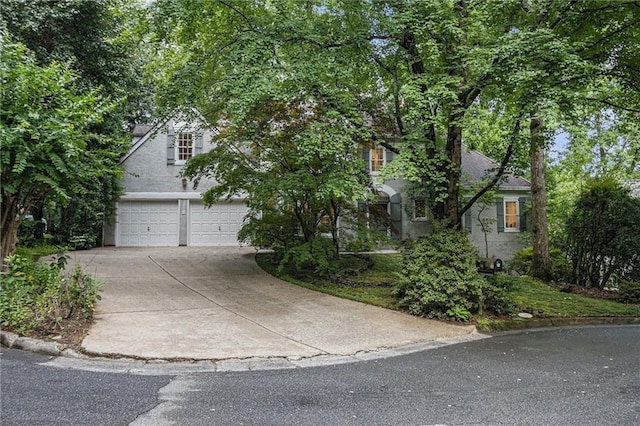 80 Stratford Pl NE, Atlanta, GA 30342 - obstructed view of property featuring an attached garage, driveway, and a chimney