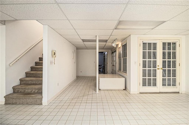 80 Stratford Pl NE, Atlanta, GA 30342 - finished basement with french doors, a drop ceiling, stairs, and tile patterned floors