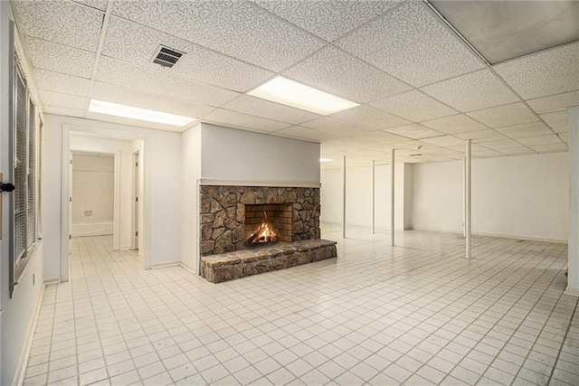 80 Stratford Pl NE, Atlanta, GA 30342 - basement with a paneled ceiling, a stone fireplace, and light tile patterned floors