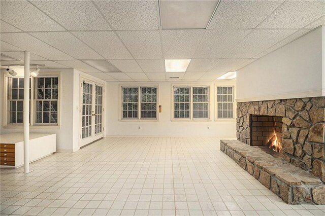 80 Stratford Pl NE, Atlanta, GA 30342 - unfurnished living room featuring a fireplace and a paneled ceiling