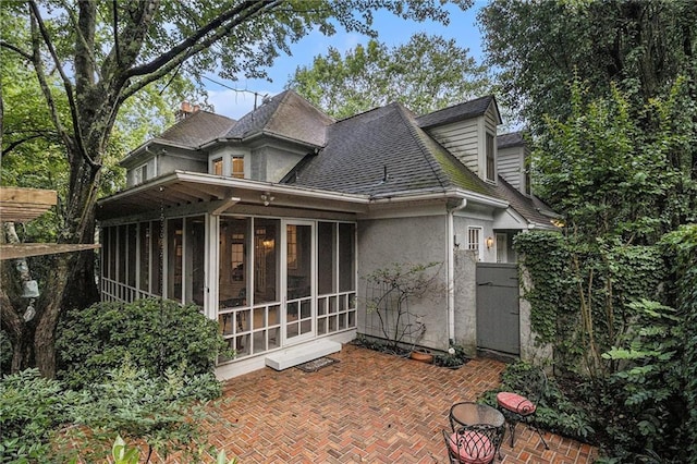 80 Stratford Pl NE, Atlanta, GA 30342 - back of property with a sunroom, a patio area, stucco siding, and roof with shingles