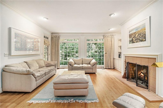 80 Stratford Pl NE, Atlanta, GA 30342 - living area with ornamental molding, a tiled fireplace, light wood-style flooring, and recessed lighting