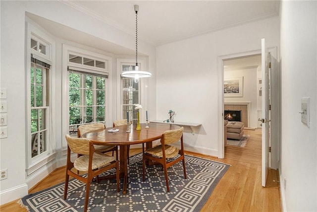 80 Stratford Pl NE, Atlanta, GA 30342 - dining area with ornamental molding, light wood-type flooring, and a tile fireplace