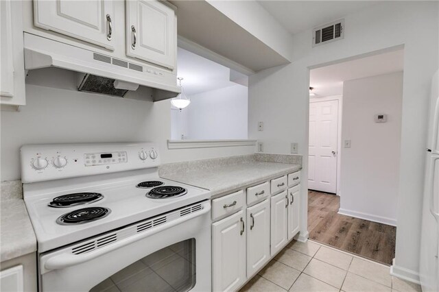 kitchen featuring white cabinets, light hardwood / wood-style flooring, and white range with electric cooktop