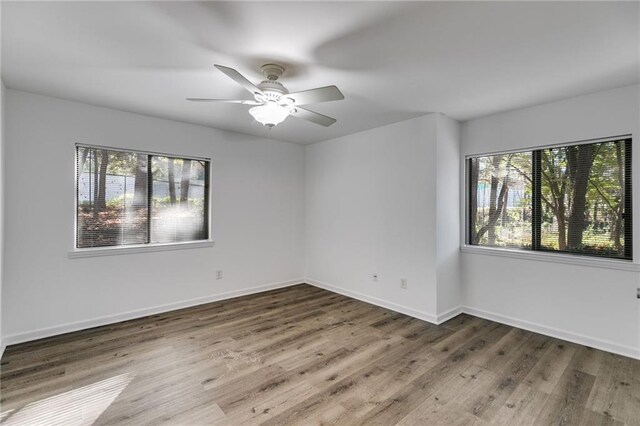 unfurnished room featuring hardwood / wood-style floors and ceiling fan