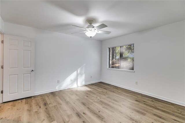 spare room with ceiling fan and light hardwood / wood-style floors