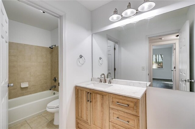 full bathroom with tile patterned floors, vanity, toilet, and tiled shower / bath