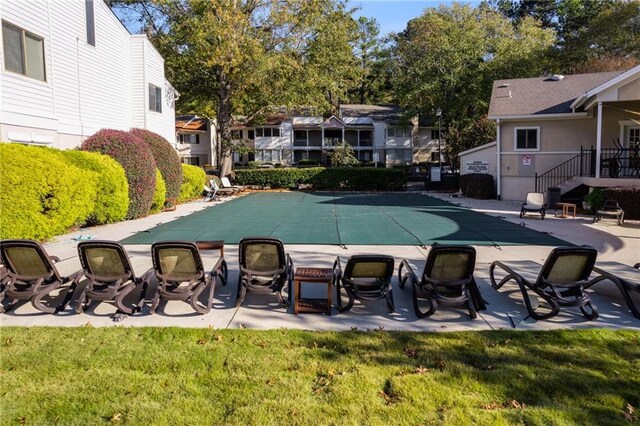 view of pool with a yard and a patio