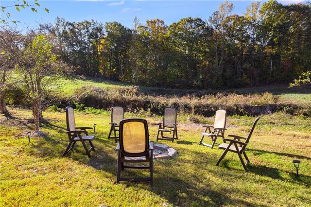 view of yard with an outdoor fire pit