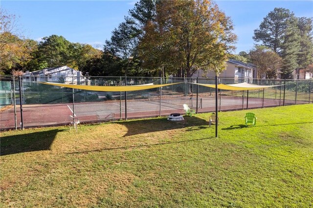 view of sport court featuring a yard