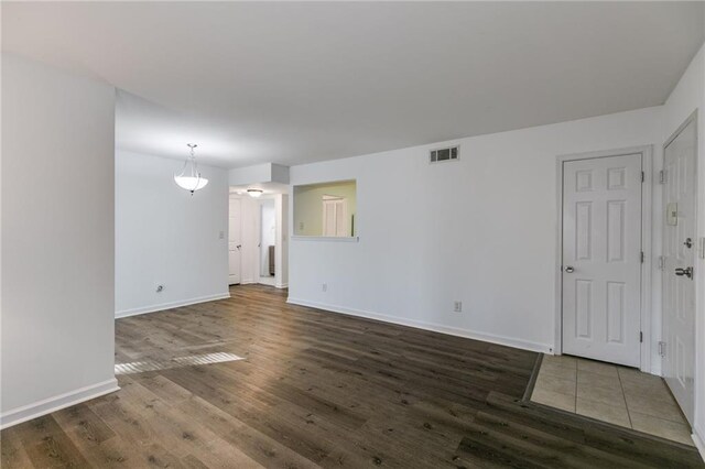 empty room with dark wood-type flooring