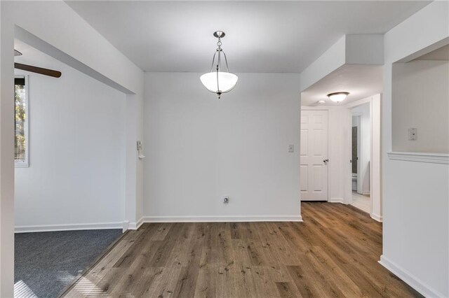 unfurnished dining area featuring dark hardwood / wood-style flooring