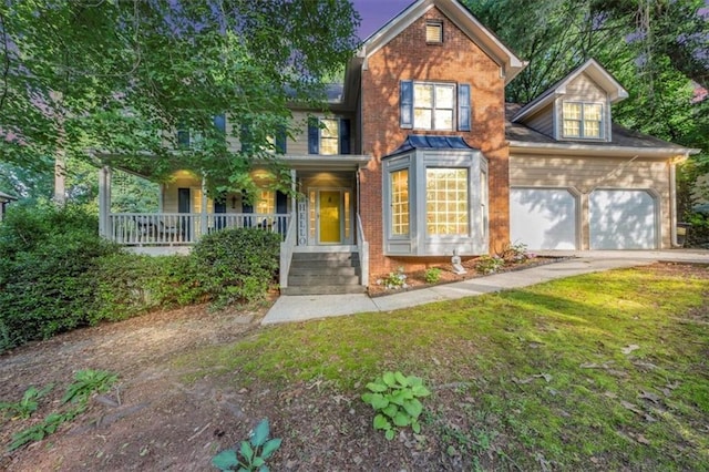 4817 Overland Dr, Powder Springs, GA 30127 - view of front facade featuring covered porch, an attached garage, brick siding, concrete driveway, and a front lawn