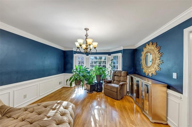 4817 Overland Dr, Powder Springs, GA 30127 - sitting room with a chandelier, crown molding, a decorative wall, wood finished floors, and a wainscoted wall