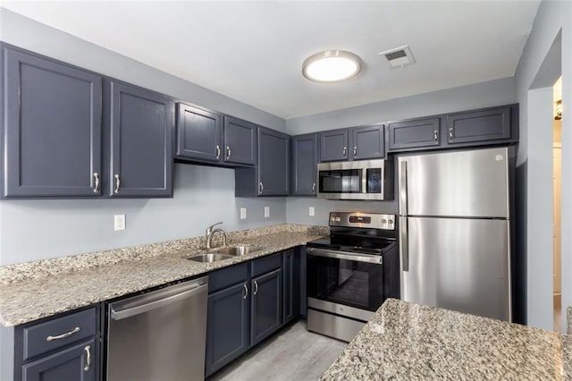 6726 Gallant Ct SE Unit 30, Mableton, GA 30126 - kitchen featuring appliances with stainless steel finishes, light wood-style floors, and light stone countertops