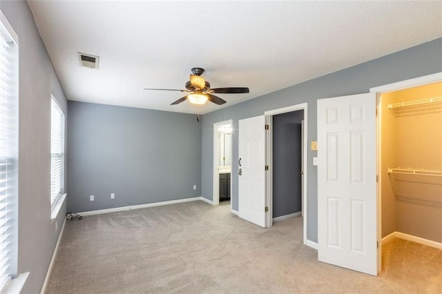 6726 Gallant Ct SE Unit 30, Mableton, GA 30126 - unfurnished bedroom featuring a walk in closet, light colored carpet, and a ceiling fan