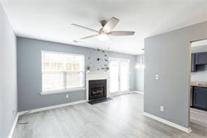 6726 Gallant Ct SE Unit 30, Mableton, GA 30126 - unfurnished living room with a ceiling fan, wood finished floors, and a fireplace with flush hearth