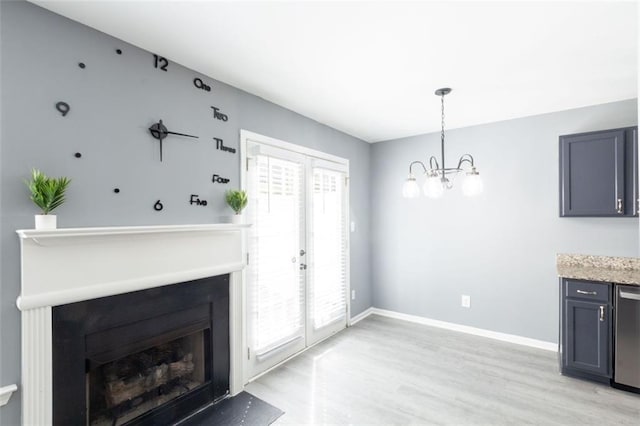 6726 Gallant Ct SE Unit 30, Mableton, GA 30126 - unfurnished living room with a fireplace, light wood-style flooring, a chandelier, and french doors