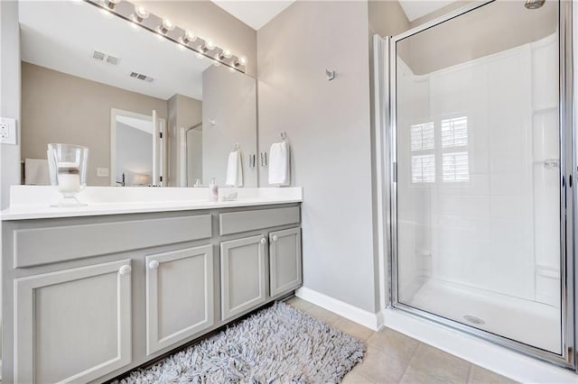 full bath featuring vanity, visible vents, tile patterned flooring, and a stall shower