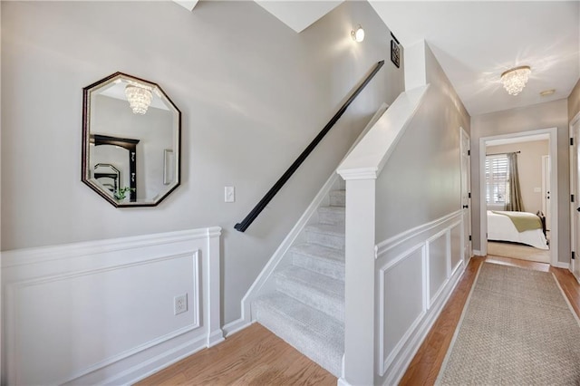 stairs featuring wood finished floors