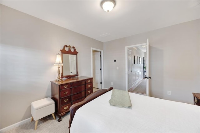 bedroom with carpet floors and baseboards
