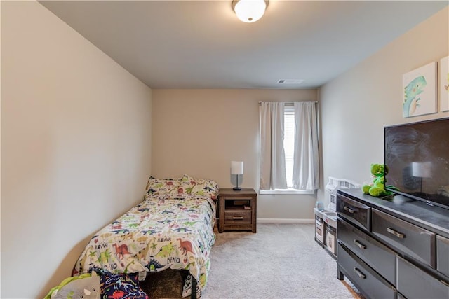 bedroom featuring visible vents, light carpet, and baseboards