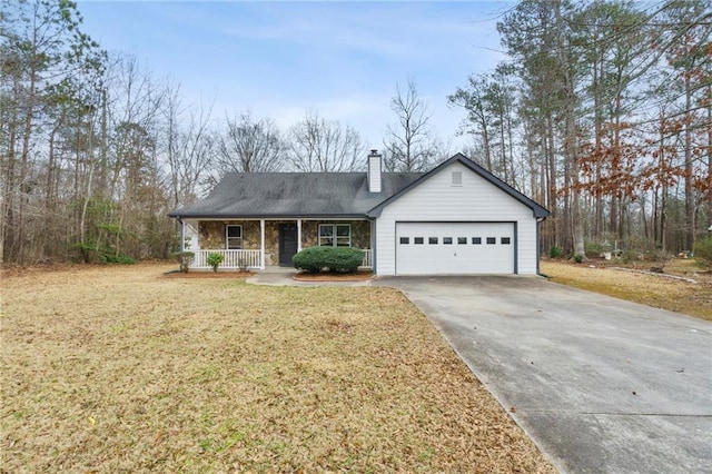 view of front facade featuring a porch, a garage, and a front lawn